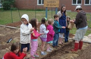 Kids and Teachers bullding a garden
