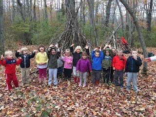 Preschoolers making small forts out of sticks